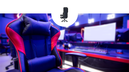 A gaming room with desk and monitor in the background and gaming chair in the foreground.