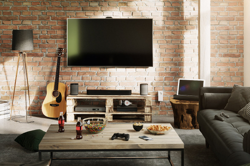 A living room with a view of a stone-look TV wall. A devolo powerline adapter is plugged into the socket.